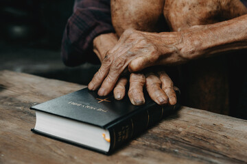 Wall Mural - Hands together in prayer to God along with the bible In the Christian concept and religion, Oldman pray in the Bible