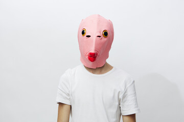 horizontal portrait of a man in a strange pink rubber mask