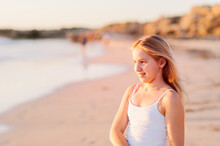 Girl At Beach With Setting Sunlight