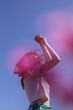 © Liliya Rodnikova/Stocksy - Young woman dancing against blue sky