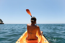 Woman In Bikini Sitting On Kayak In Sea