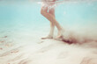 © Ibai Acevedo/Stocksy - Underwater woman feet walking on tropical sea bottom