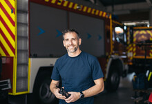 Portrait of firefighter using walkie talkie