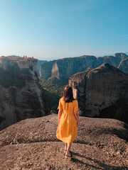 Wall Mural - beautiful woman in yellow dress at greece thessaly mountains