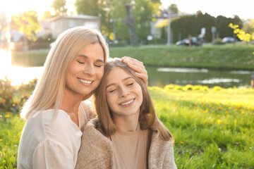 Sticker - Happy mother with her daughter spending time together in park on sunny day