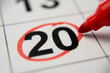© Grustock - The calendar 20th day of the month is circled. A red marker circles the twentieth day of the month from the paper calendar. A very important date in the calendar