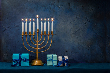 Jewish Hanukkah Menorah 9 Branch Candlestick, gift box. Holiday Candle Holder. Nine-arm candlestick. Traditional Hebrew Festival of Lights candelabra. Background for design with copy space