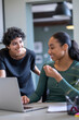 © Cultura Creative - Young women working on laptop in office