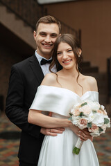 Wall Mural - young couple bride and groom in a white short dress