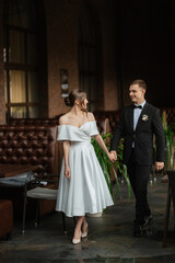 young couple bride and groom in a white short dress