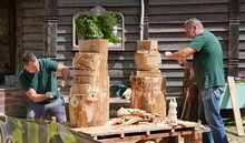 Bryansk, Russia - July 2022: Wood Carvers Are Working On Making Wooden Sculptures With A Hammer And Chisel In The City Park On The Street In The Summer During A Master Class