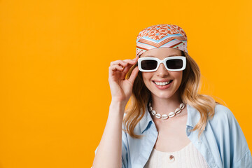 Young blonde woman wearing sunglasses smiling at camera