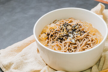 Korean food Naengmemilguksu, a winter delicacy, this buckwheat noodle dish is served in a cold chicken- or beef-based broth and topped with cold slices of beef and egg as a garnish.