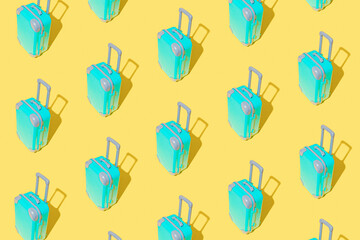 Blue travel plastic suitcases pattern on yellow background. Bags on wheels for business trip, summer vacation, travel.