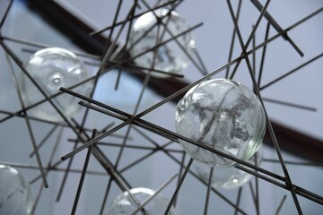 Wall Mural - Closeup shot of a beautiful lamp with a contemporary design hanging in the air