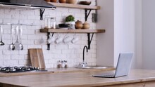 Interior Design Of Laptop On Kitchen Desk With White Brick Wall And Range Hod