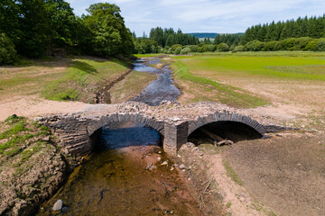 Wall Mural - An old, usually submerged bridge at a near empty reservoir during a heatwave