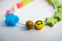 Closeup Shot Of A Beaded Bracelet With Stars And A Yellow Smiley Face