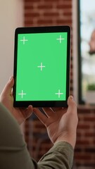 Poster - Vertical video: Office worker analyzing greenscreen template on digital tablet, working on business with isolated chroma key on gadget. Looking at display with blank mockup and copyspace background.