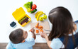 Top view mother with son preparing school snack or lunch in home kitchen. Concept healthy school food for schoolchild