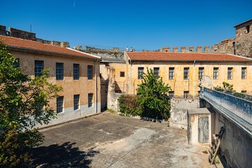 Wall Mural - Courtyard of buildings near the Thessaloniki fortress with brown roofs and yellow walls