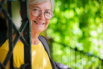 Sticker - Portrait of beautiful senior woman during visit of Alcazar gardens in Seville - vacation travel tourism concept