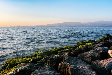 Sticker - A  seascape at the sunset with water flowing on the stones