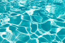 Turquoise Color Background Of Swimming Pool Water With Ripples In Summer
