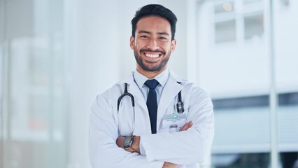 Poster - One medical professional looking proud and confident after completing a surgery. Portrait of a male doctor laughing and smiling while standing with arms crossed at a hospital alone.