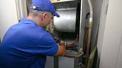 Wall Mural - HVAC Technician Hooking up a Blower Motor