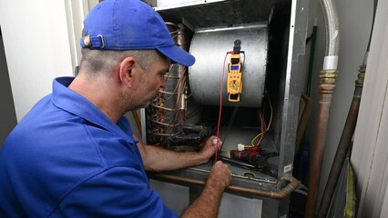 Wall Mural - HVAC Technician Checking Voltage on a Wiring Harness