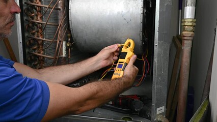 Wall Mural - HVAC Technician Checking Current on Motor Wire