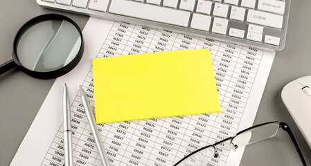 Poster - Office workplace table with keyboard, chart , magnifier and yellow sticky, Flat lay. Top view.