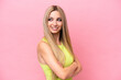 © luismolinero - Pretty blonde woman isolated on pink background looking to the side and smiling