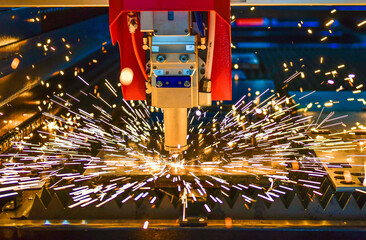 Wall Mural - industrial laser cut machine while cutting the sheet metal with the sparking light.