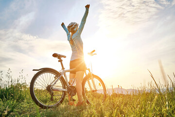 cyclist woman riding bike in helmets go in sports outdoors on sunny day a mountain in the forest. si