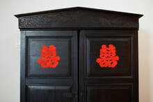 Chinese Wording Double Happiness Sticker On A Dark Brown Vintage Cupboard