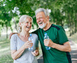 © Lumos sp - outdoor senior fitness woman man cheerful laughing smiling active sport exercise healthy fit runner couple running jogging elderly mature water bottle drink thirsty