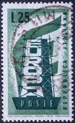 Wall Mural - ITALY - CIRCA 1956: a postage stamp from ITALY , showing the word Europe vertically in a steel framework in front of a European flag. Circa 1956