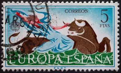 Wall Mural - Spain - circa 1966: a postage stamp from Spain, showing a man taking a bull by the horns. CEPT emblem . Text: Europe