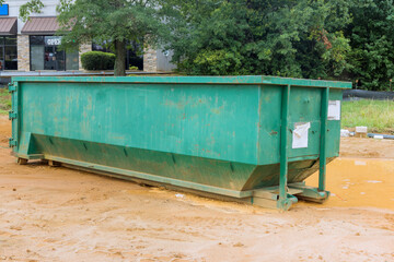 Wall Mural - Using a metal container trash dumpster for recycling garbage is considered good idea on construction site