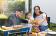 © atitaph - Asian family happy, bright, cute daughter, barbecues in the cour