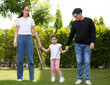 © atitaph - Asian family, bright and cute daughters are relaxing as parents walk their children on the lawn.
