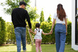 © atitaph - Asian family, bright and cute daughters are relaxing as parents walk their children on the lawn.
