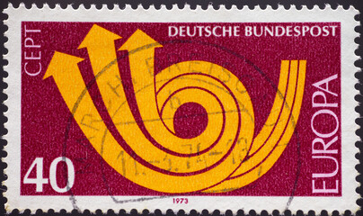 Wall Mural - GERMANY - CIRCA 1973: a postage stamp from GERMANY, showing a stylized post horn. Text: Europe, CEPT. Circa 1973