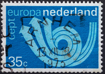 Wall Mural - NETHERLANDS - CIRCA 1973: a postage stamp from NETHERLANDS , showing a stylized post horn. Text: Europe, CEPT. Circa 1973