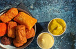 Closeup of bowl traditional typical dutch breadcrump fried meat based finger street food snack (bitterballen garnituur) with mayonnaise and mustard sauce dips - Netherlands