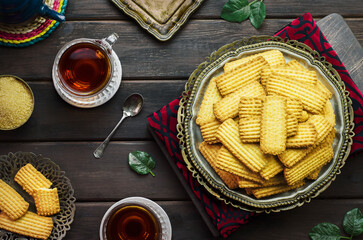 Wall Mural - Cookies for celebration of El Fitr Islamic Feast(The Feast that comes after Ramadan).Delicious traditional Biscuits served with cup of tea. Close up with copy space.