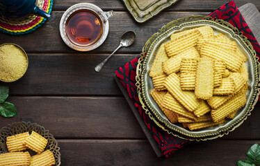 Wall Mural - Cookies for celebration of El Fitr Islamic Feast(The Feast that comes after Ramadan).Delicious traditional Biscuits served with cup of tea. Close up with copy space.