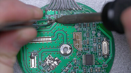 Poster - Microcircuit being fixed with soldering iron. Computer repair concept. Tweezers with chip and soldering Iron. soldering iron and microcircuit. microcircuit, microchip, integrated circuit